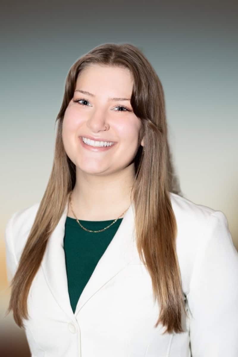 Grace Kutz, eating disorder therapist at Serengeti Wellness, smiling in professional attire, promoting culturally attuned mental health care in Chicago.