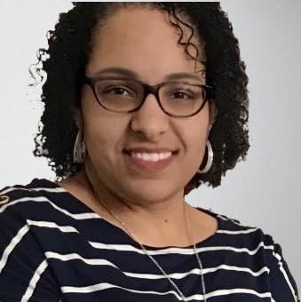 A woman with curly hair wearing a striped navy blue shirt and glasses, representing the Serengeti Wellness support team.