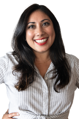 Smiling woman with long dark hair wearing a striped blouse, representing Sabina Bhasin, a therapist at Serengeti Wellness, specializing in trauma-informed care and mental health support.